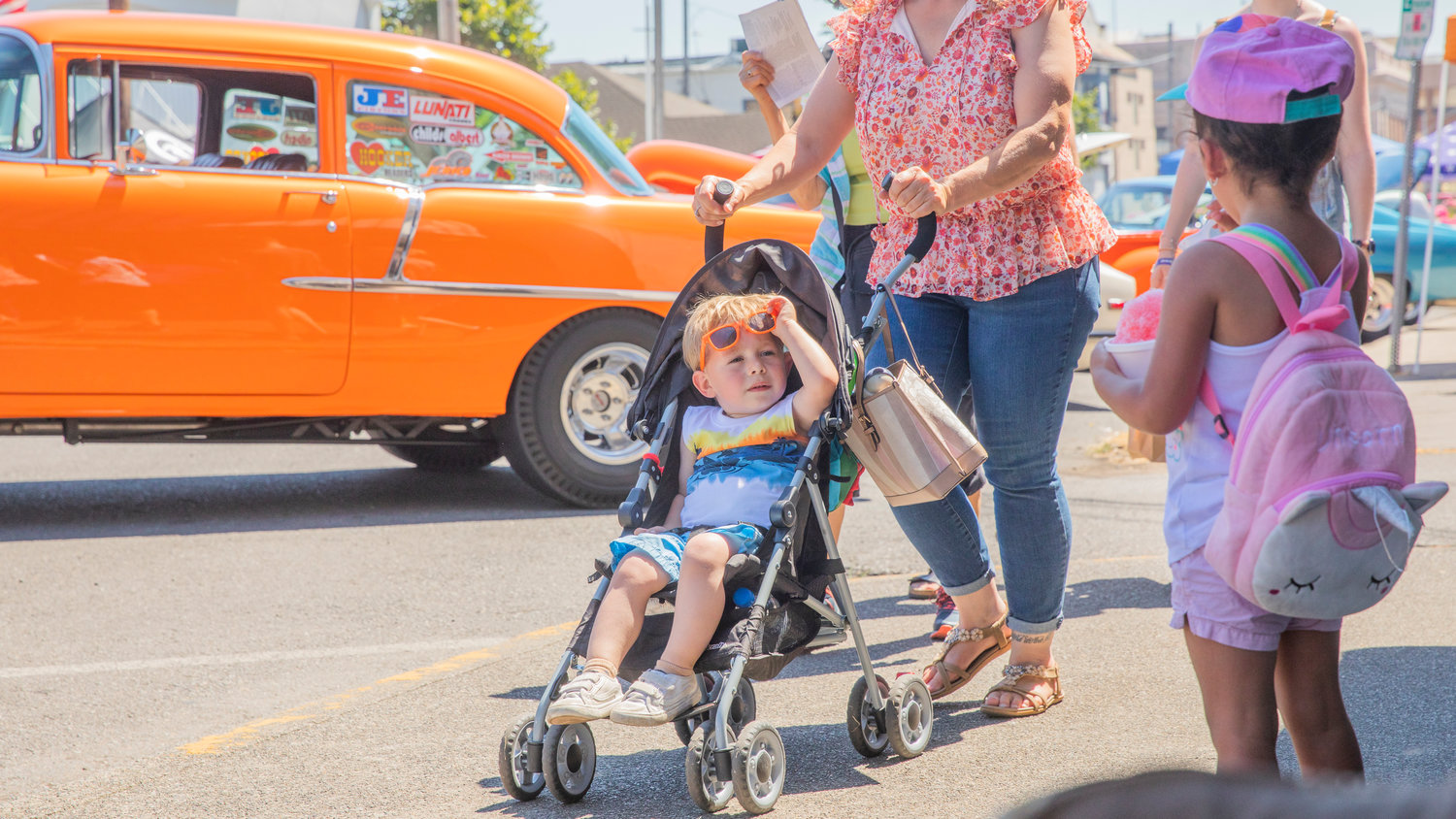 Austin Cunningham, 2,  raises his sunglasses and takes in the views as classic cars sit on display during Chehalis Fest Saturday afternoon.